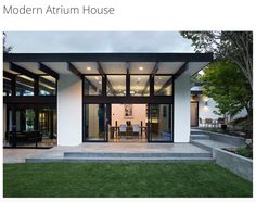 the modern atrium house has glass walls and doors