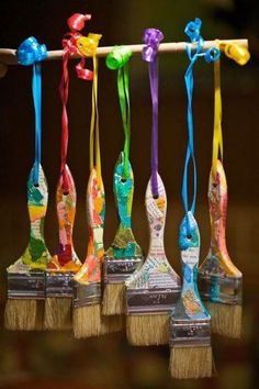 six colorful brushes are lined up on top of each other with ribbons attached to them