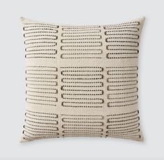 a white pillow with holes on it