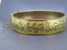 Stunning vintage hinged bracelet with beautiful floral detailing, stunning piece.  Has a box clasp that works great.  Great detail.  Has some age related wear and patina. Signed with a patent.  Visit Ribbons Edge for more great pieces of vintage and antique jewelry!  All items added to your cart at Ribbons Edge will automatically combine shipping. To stay up to date with my newest offerings, follow me on IG @ RibbonsEdge Vintage Hinged Bangle, Vintage Hinged Bracelets For Wedding, Vintage Hinged Cuff Bracelet, Victorian Etched Cuff Bracelet For Formal Occasions, Antique Hinged Cuff Bracelet For Formal Occasions, Vintage Hallmarked Cuff Bracelet For Formal Occasions, Vintage Engraved Cuff Bracelet For Formal Occasions, Vintage Engraved Cuff Bracelet For Formal Events, Formal Vintage Hallmarked Cuff Bracelet