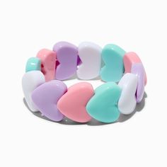 a colorful bracelet with hearts on the front and back of it, against a white background