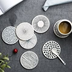 several plates and cups are arranged on a table with a cup of coffee next to them