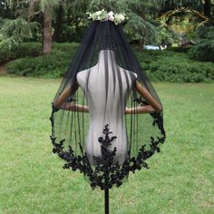 the back of a mannequin wearing a veil with flowers on it