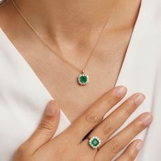 Dainty and feminine, our Emerald Princess Ring from the Envy collection is an instant icon. A dazzling emerald fusion stone ring serves as the focal point from a delicate masterfully crafted from hypoallergenic 925 sterling silver and plated in 14K gold. This timeless design is completed with the addition of round-cut cubic zirconia enveloping the emerald to make the vibrant green pop all the more. Metal: 925 Silver Plating: 14K Gold E-coated Size: 6-9 Adjustable Stone: Emerald Fusion Stone with Luxury Fine Jewelry Emerald Necklace, Emerald Pendant Design, Emerald Sets Jewellery, Elegant Emerald Ring With Halo, Elegant Emerald Rings With Halo, Exquisite Emerald Cut Halo Design Jewelry, Exquisite Emerald Cut Halo Jewelry, Fine Jewelry Emerald Ring With Halo Design, Elegant Sterling Silver Emerald Ring With Halo Design