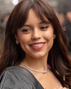 a close up of a person wearing a necklace