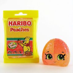 a bag of harbo peaches next to an orange with its eyes open