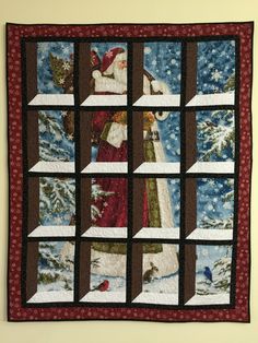 a man standing next to a christmas quilt on a window sill with santa in it