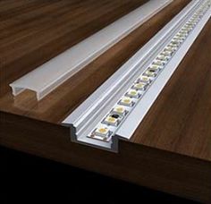 an image of led strip light on wooden table top with white trims and brown wood flooring