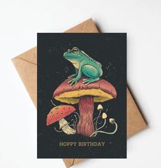 a card with a frog sitting on top of a mushroom