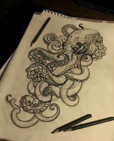 an octopus drawing on paper with pencils