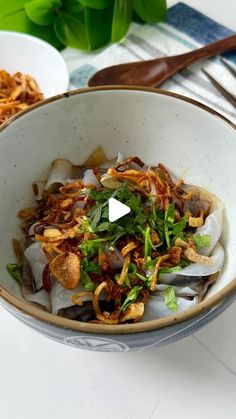 a bowl filled with food sitting on top of a table