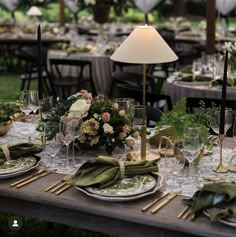 the table is set with green napkins and place settings for an elegant dinner party