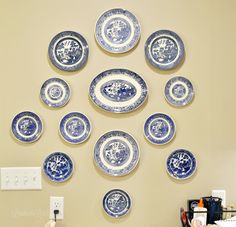 blue and white plates are arranged on the wall