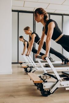 three women doing pivots on treadmills in a gym