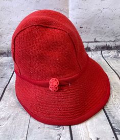 1960s Vintage Red Wool Bucket/Cloche Hat This is such a beautiful and stylish vintage hat in vibrant red wool. Classic 1920s cloche style/bucket shape. Non stretch with lining and two small red decorative plastic buttons on the side. Inner label is 'exclusive to Daphne, St Anne's on Sea'. Small size - inner circumference is approx 20". In very good vintage condition. Colour - Red Era - 1960s Brand - Daphne Material - Wool Condition - Very good vintage condition VIN4172 Please check out our other Vintage Red Hat For The Beach, Red Retro Hat With Curved Brim, Retro Red Hat With Curved Brim, Vintage Red Fedora Hat, Vintage Red Fedora Felt Hat, Red Wool Brimmed Hat, Vintage Red Bucket Hat, Red Wool Hat With Short Brim, Red Adjustable Brimmed Cloche Hat