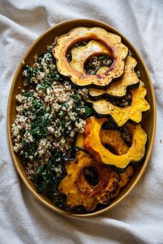 a plate filled with rice, squash and spinach