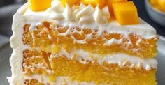 a piece of cake with white frosting and orange slices on top