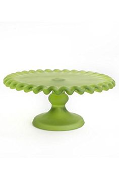 a green cake plate sitting on top of a white table