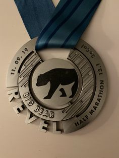 a silver medal with a blue ribbon around it