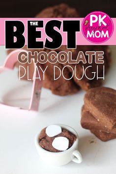 the best chocolate play dough is in a white cup with marshmallows on top