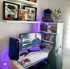 a computer desk with a monitor, keyboard and mouse on it in front of some shelves