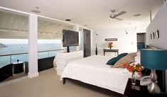 a bedroom with a large bed and ocean view