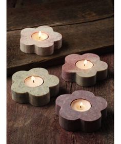 three small candles sitting on top of a wooden table