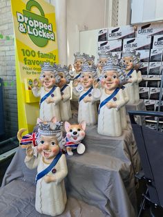 a table topped with lots of figurines wearing crowns