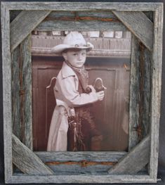 an old photo of a young boy dressed in cowboy gear and holding a pair of scissors