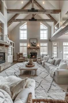 a living room filled with furniture and a fire place in the middle of an open floor plan