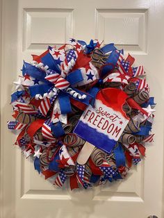 a patriotic wreath is hanging on the front door