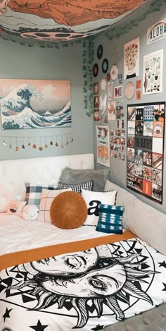 a bed room with a neatly made bed and pictures on the wall above it's headboard