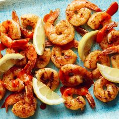 shrimp with lemon wedges and ketchup on a blue plate