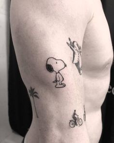 a man's arm with a small tattoo of a dog and a person riding a bike