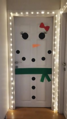 a door decorated with christmas lights and a snowman's head on the front