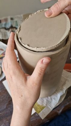 someone is making a vase out of clay