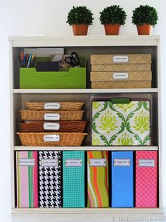 an organized bookcase with books, binders and other office supplies on top of it