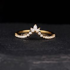 a gold ring with white stones on it