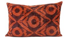 an orange and brown pillow on a white background