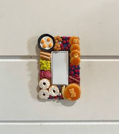 a decorative switch plate with food on it and a light switch cover in the shape of a rectangle