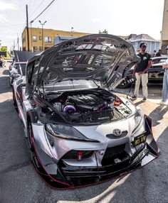 a toyota sports car with its hood open