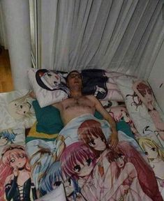 a man laying on top of a bed covered in anime sheets