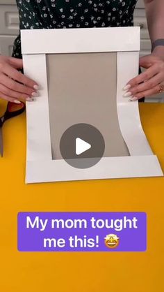 a woman holding up a paper cutout with the words my mom taught me this