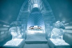 an ice hotel with two beds in the middle and three polar bears on each bed