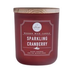 a candle that is sitting on top of a white surface with the words sparkling cranberry