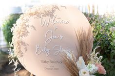 a welcome sign for a baby shower with flowers