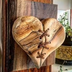 a wooden heart hanging on the side of a door