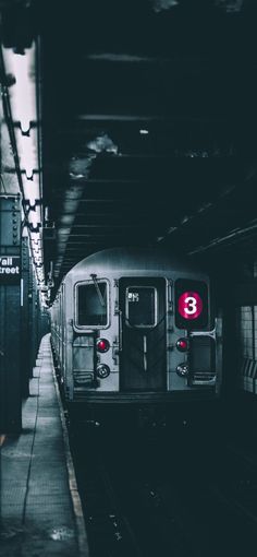 a subway train pulling into the station at night