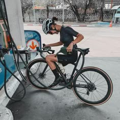 a man is pumping gas into his bike