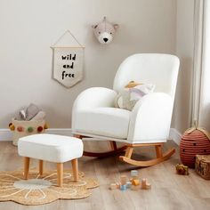 a white rocking chair and ottoman in a child's room